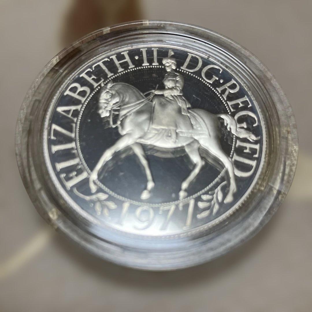 1977 United Kingdom 25 Pence Silver Coin – Silver Jubilee – NGC: A commemorative 25 Pence silver coin issued in 1977 to celebrate the 25th anniversary (Silver Jubilee) of the reign of Elizabeth II. This coin marks an important historical milestone in British royal