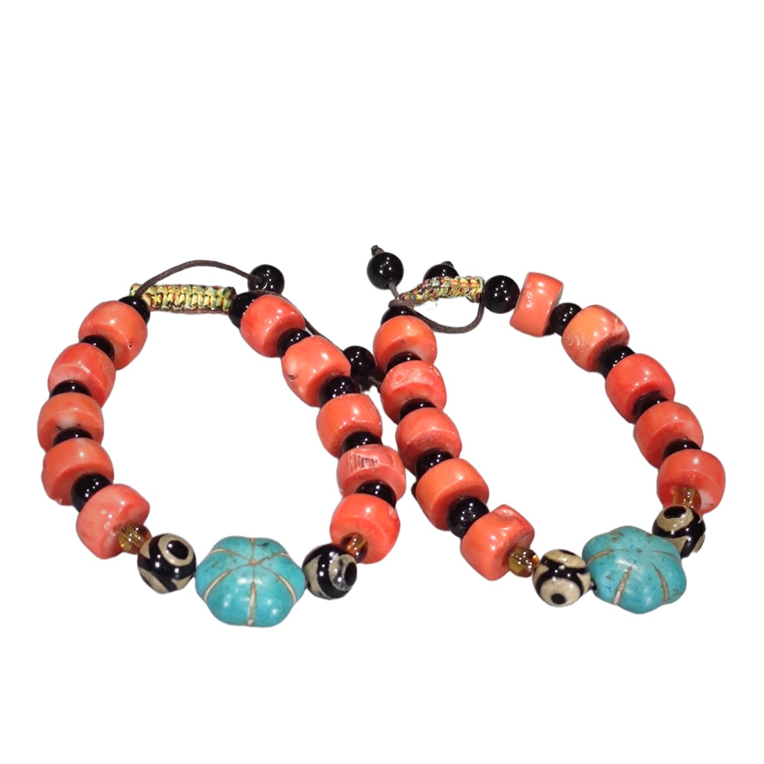 A pair of Qing Dynasty red coral bracelets.: A pair of Qing Dynasty red coral bracelets, with bead diameters of 13mm and thickness of 7mm, weighing 36g and 39g respectively.