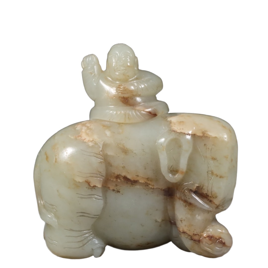 Qing Dynasty Hetian jade seed material boy riding elephant water vessel.: This Qing Dynasty Hetian jade seed material water vessel features a boy riding an elephant, measuring 9.2x9.4x6.2cm and weighing 169.5 grams. The jade is delicate and warm, with a gentle and subtle