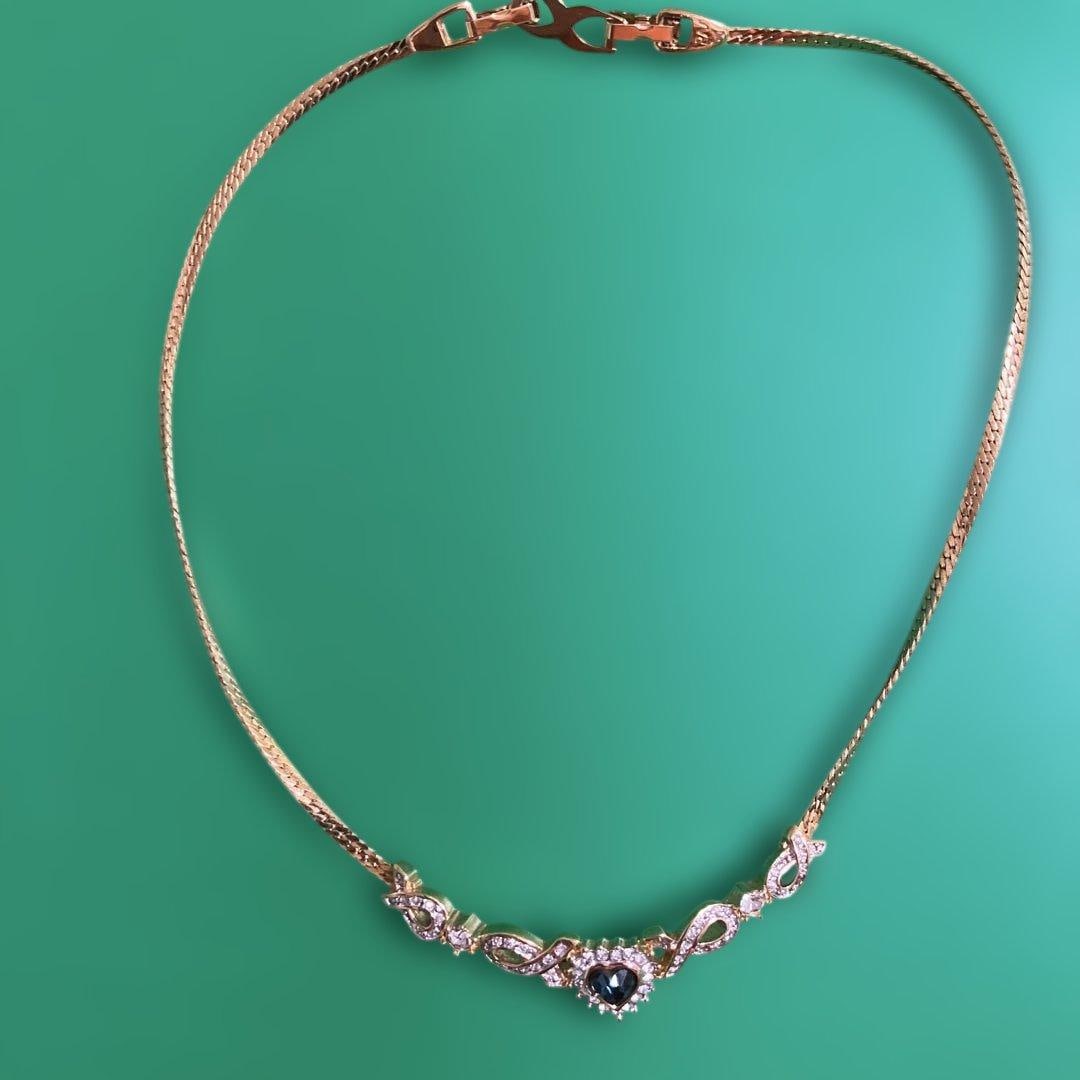 (Second-hand) Nina Ricci Gold Heart-shaped Necklace: A gold necklace with a heart-shaped gemstone. Color: Gold Design: Heart-shaped stone and decoration Material: Metal - Closure: Clasp Size: Approximately 14 cm on each side, decoration part about 7 cm