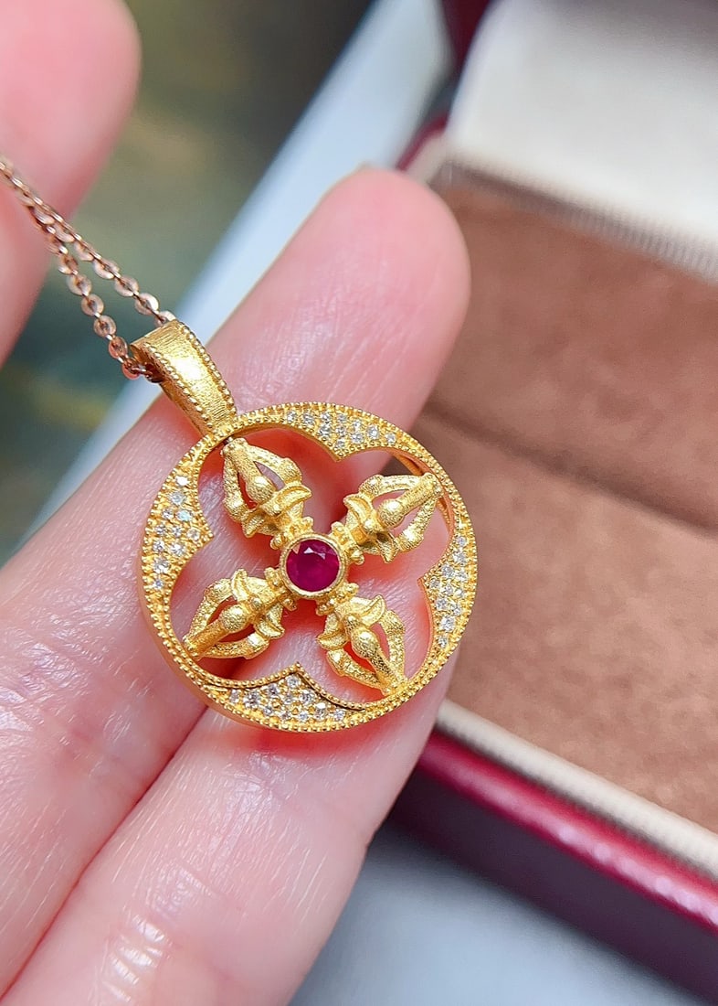 18K Gold Ruby Emerald Pendant: This exquisite 18K Gold Ruby Emerald Pendant is a testament to refined elegance, featuring a dual-sided design that beautifully showcases both vibrant gemstones. The intricate craftsmanship ensures