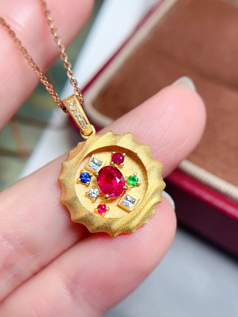 18K Gold Ruby Pendant: This pendant embodies the allure of a vivid, pigeon-blood red ruby, elegantly set in luxurious 18K gold. The glass-like clarity of the ruby enhances its fiery hue, making it a statement piece that pro