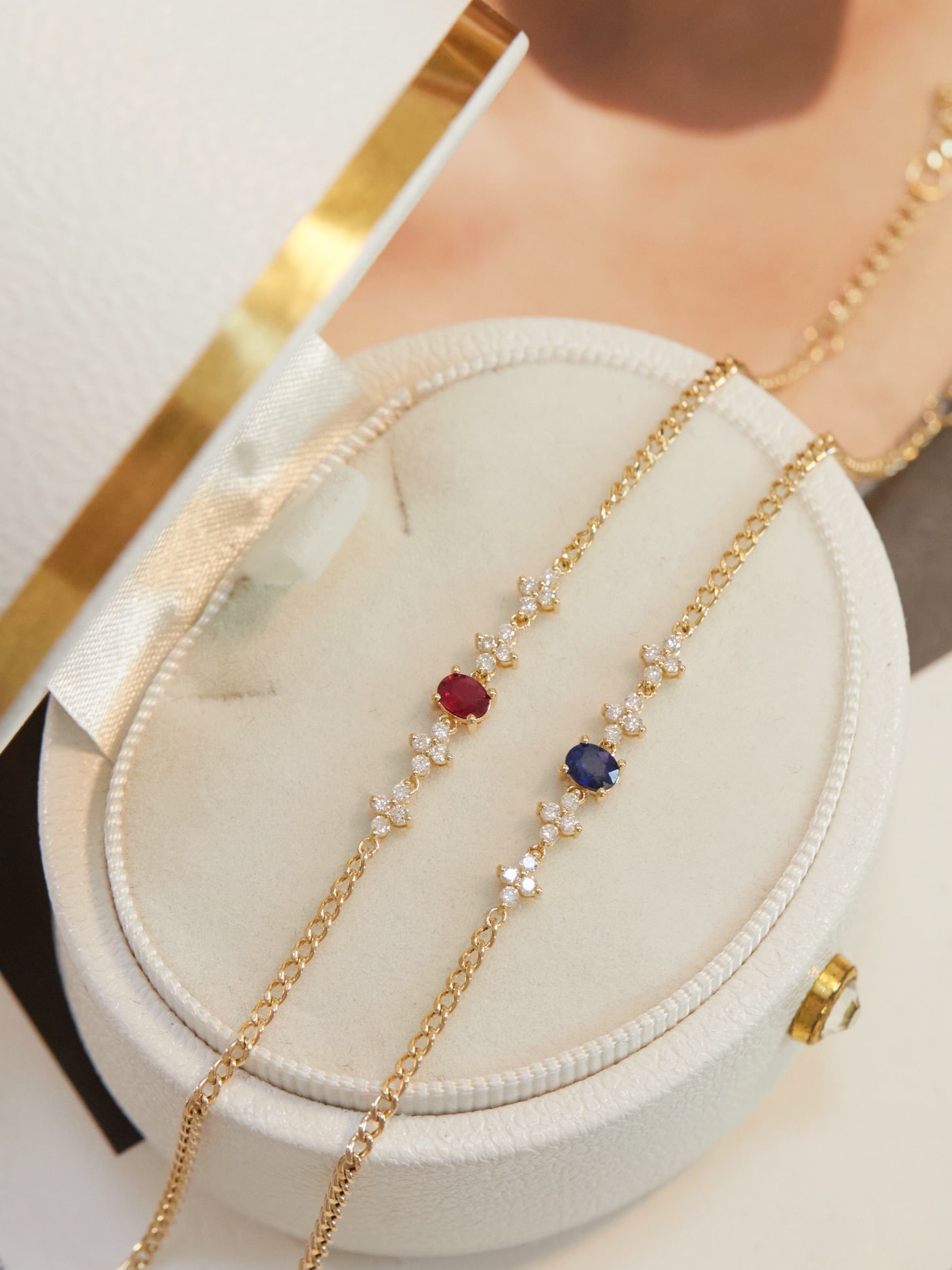 18K Gold Ruby and Sapphire Diamond Bracelet: This exquisite bracelet showcases a stunning combination of vibrant rubies and sapphires, elegantly accentuated by delicate diamond clover motifs. Its fashionable design adds a touch of