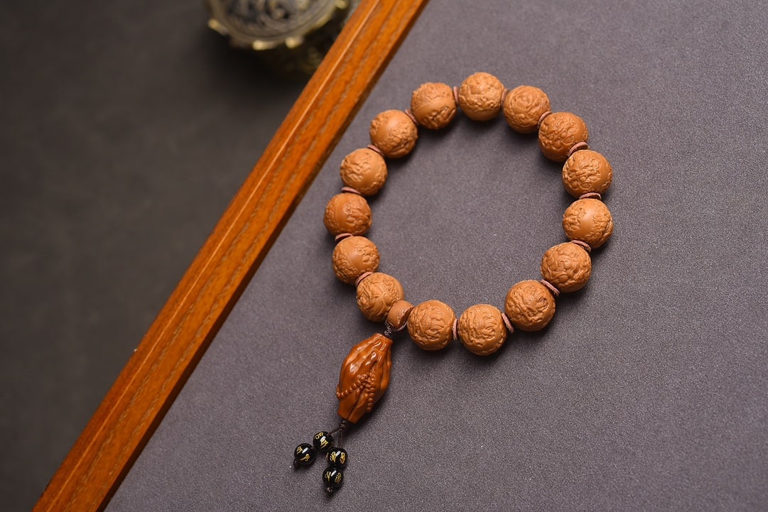 Natural Walnut Bead Bracelet: This exquisite bracelet showcases the artistry of natural walnut beads, each meticulously carved with precision to reveal intricate dragon and Buddha motifs. The beads are of unmatched quality, free f