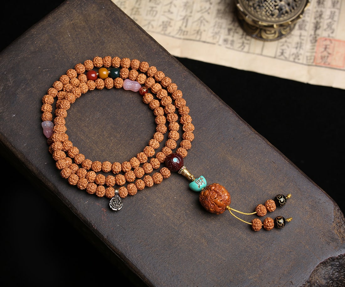 Gold Bodhi Bead Bracelet: This bracelet is a captivating multi-strand creation featuring 108 original color small Vajra Bodhi beads. Each bead is meticulously crafted with five-petal short piles, showcasing a full dragon meat