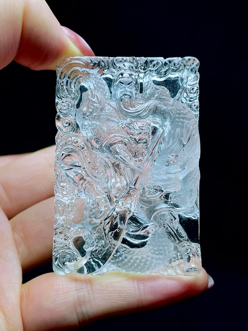 Crystal Pendant: This pendant embodies the majestic presence of the revered 'God of Wealth', crafted in pure crystal with a pristine, clear body. The exquisite double-sided carving captures a powerful and valiant imag