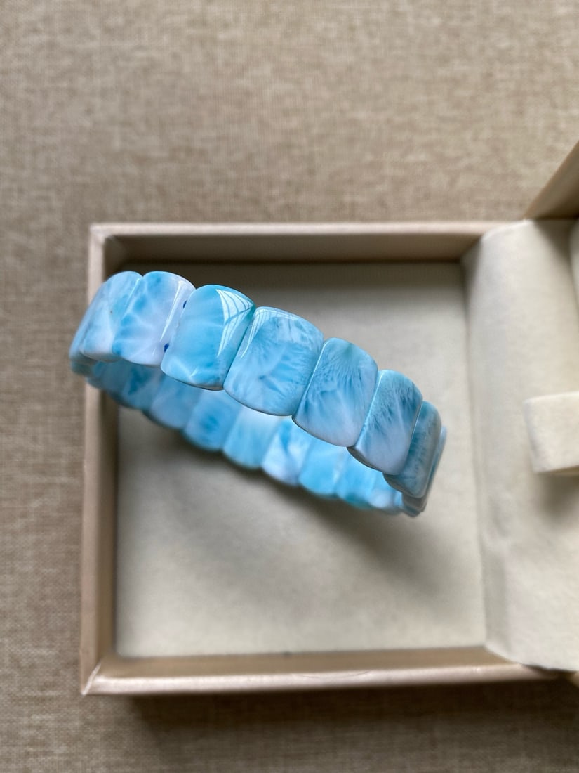 Natural Larimar Bracelet: This natural larimar bracelet exudes a serene elegance with its soothing energy and ability to release and dissolve stress. Known for its calming properties, larimar is believed to correspond with