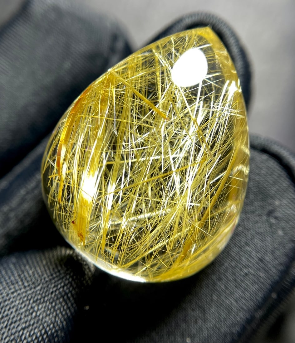 Gold Rutilated Quartz Pendant: This pendant showcases the captivating allure of natural rutilated quartz, renowned for its crystal clarity and striking golden threads that shimmer with every movement. The pendant's exquisite