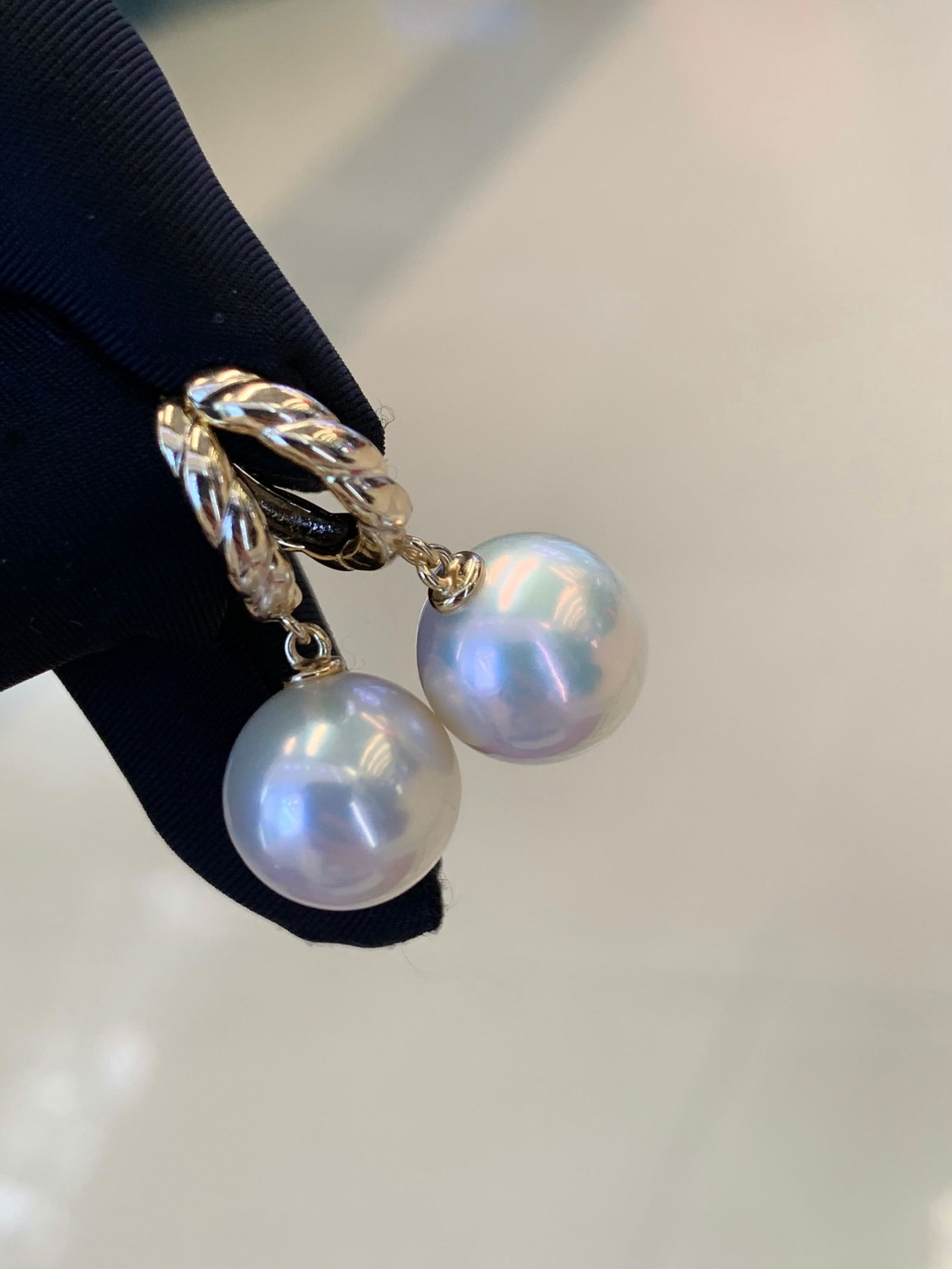 Edison Pearl Earrings: This pair of exquisite pearl hoop earrings embodies timeless elegance with their immaculate round pearls, measuring 11-12mm. The pearls are of a pristine quality, with minimal blemishes and a smooth,