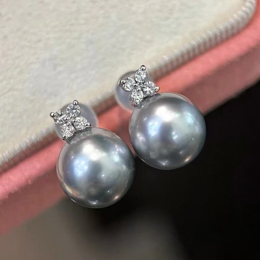 18K Gold Tahitian Pearl Earrings: This exquisite pair of 18K Gold Tahitian Pearl Earrings captures the essence of timeless elegance. The pearls, with their perfect roundness and natural gray hue, exude a sophisticated charm that is bo