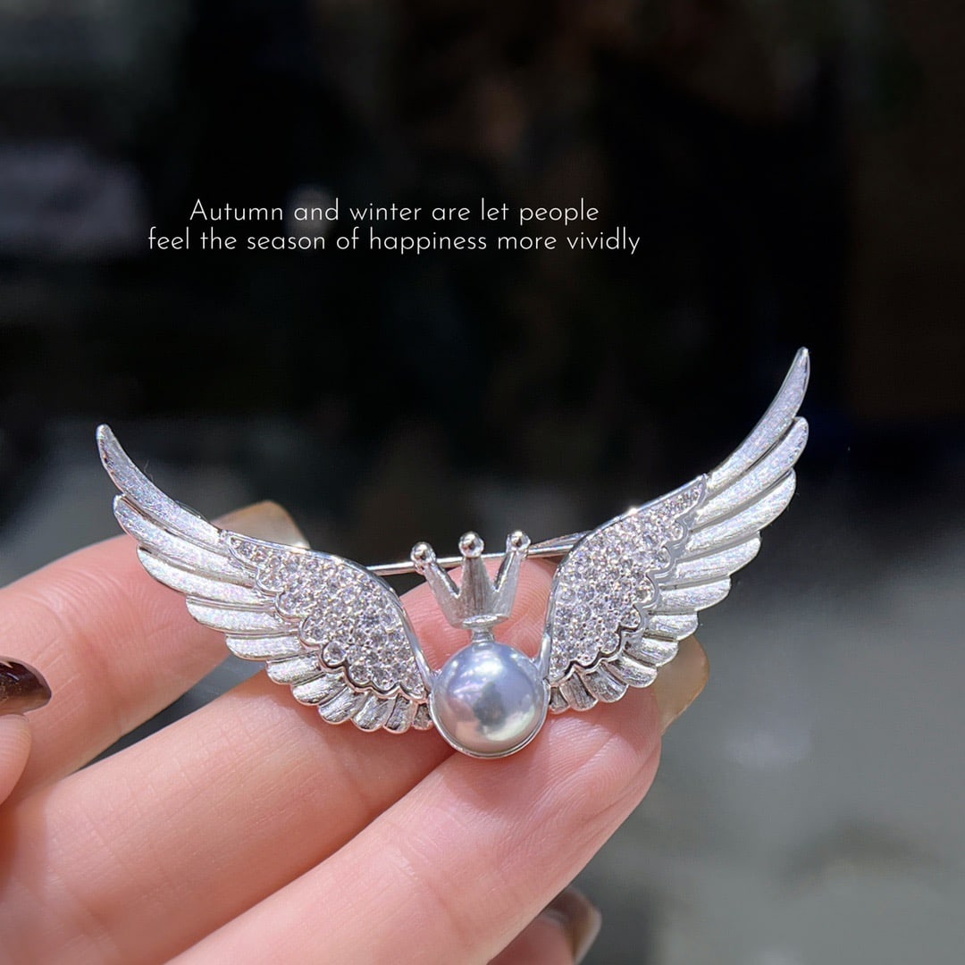 18K Gold Pearl Brooch: This exquisite brooch is a gentle whisper of time, capturing the essence of elegance with every detail. Designed in the shape of angel wings, it beautifully complements the lustrous freshwater pearl t