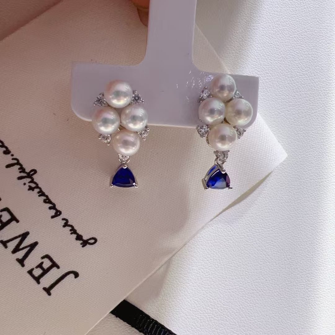 Silver Pearl Earrings: This pair of silver pearl earrings exudes an irresistible allure with its delightful array of colorful stones. The playful yet gentle design is perfect for summer, offering a chic and eye-catching app