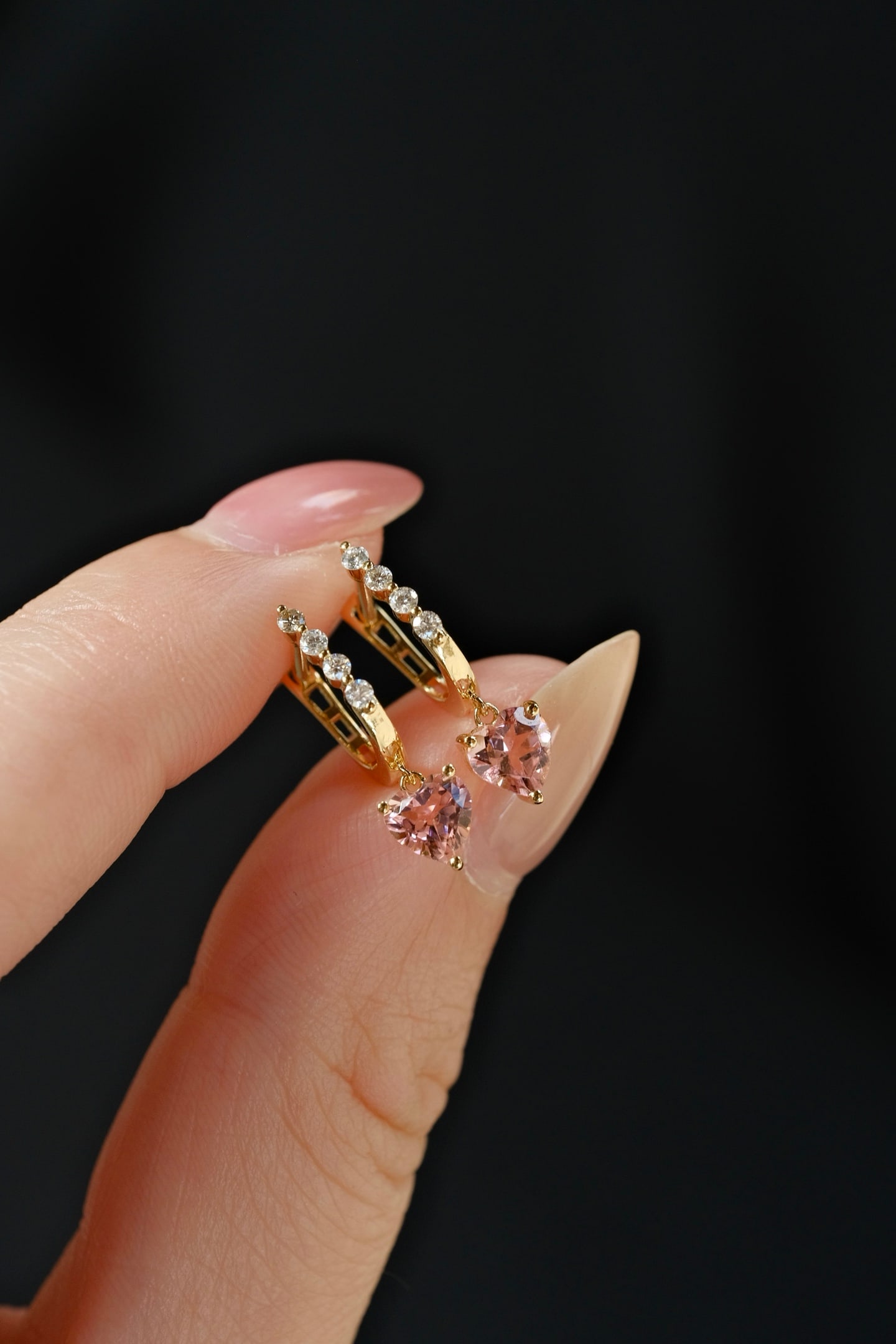 18K Gold Tourmaline Earrings: This exquisite pair of 18K Gold Tourmaline Earrings captures the essence of elegance with its natural heart-shaped tourmaline, beautifully accented by a row of sparkling diamonds. The design is both