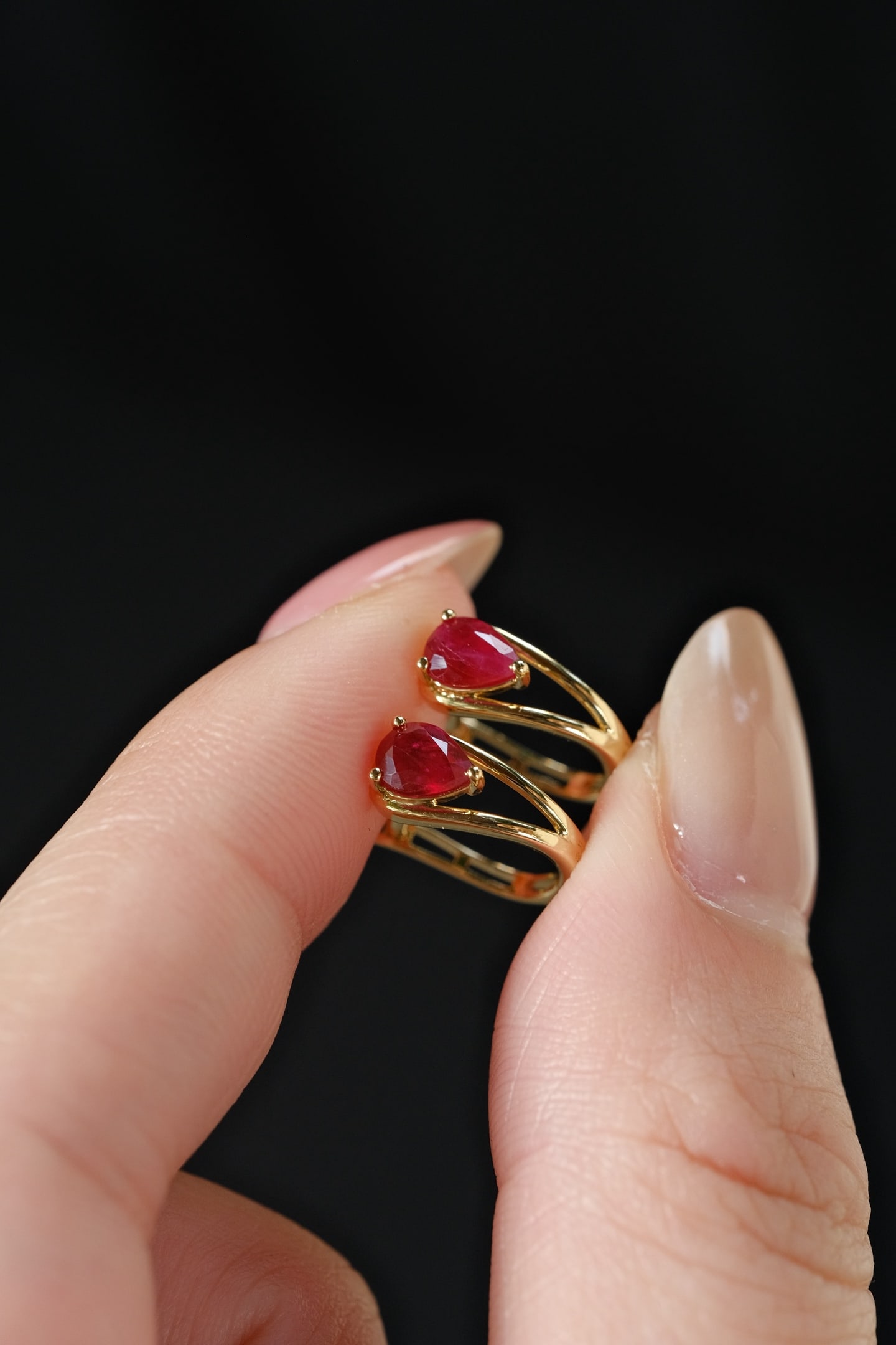 18K Gold Ruby Earrings: This pair of 18K Gold Ruby Earrings showcases the natural beauty of pigeon blood red rubies, renowned for their vivid and captivating hue. The elegant design features a sleek waterdrop motif with