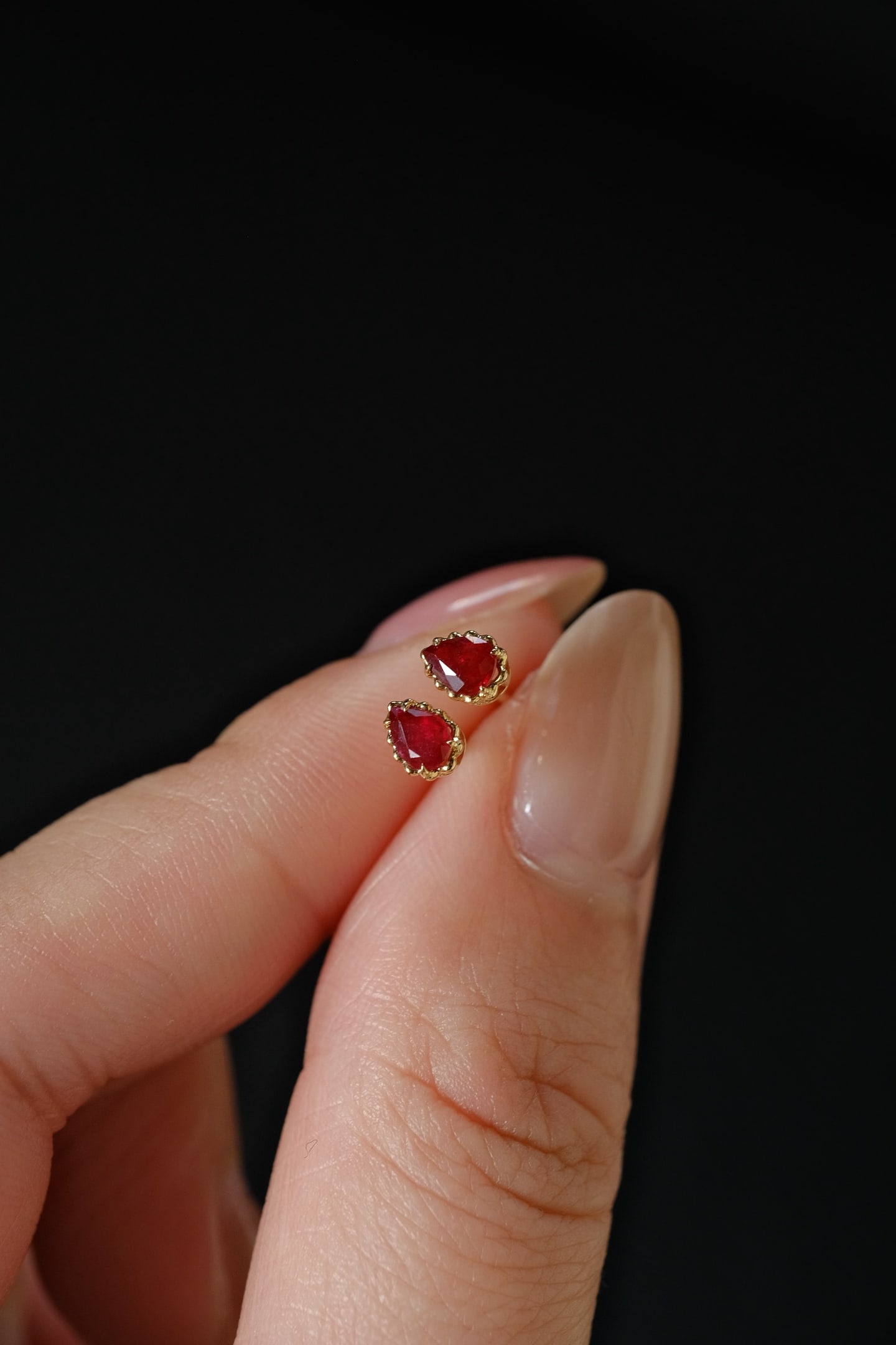 18K Gold Ruby Earrings: This exquisite pair of 18K Gold Ruby Earrings captures the essence of elegance with its claw-set natural rubies. The earrings are available in both teardrop and oval designs, offering versatile