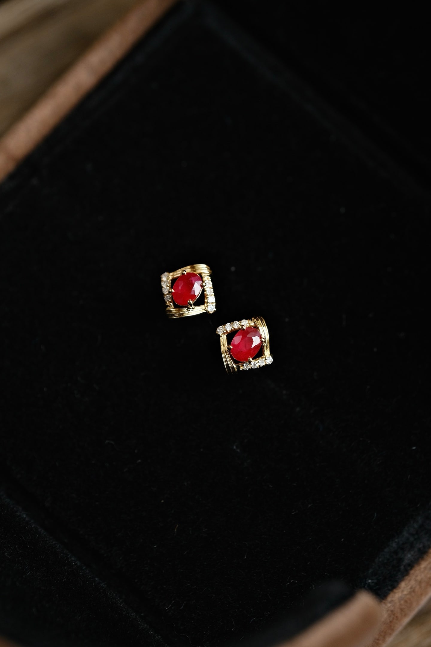 18K Gold Ruby Earrings: This exquisite pair of earrings showcases the natural beauty of pigeon's blood red rubies, elegantly accented with diamonds for an added touch of brilliance. The geometric brushed design enhances the