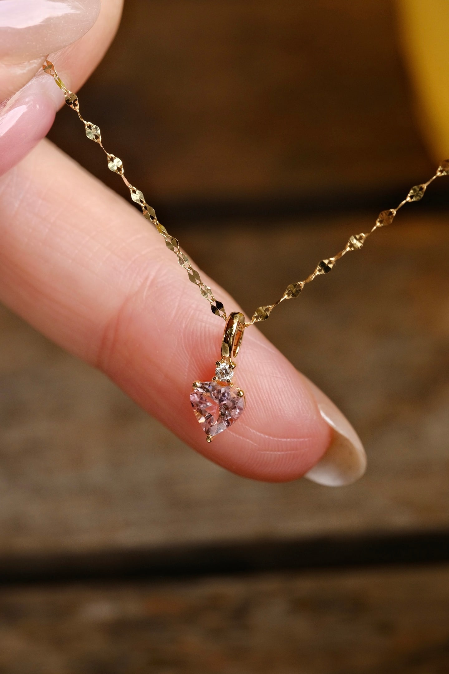 18K Gold Tourmaline Diamond Pendant: This exquisite 18K Gold Tourmaline Diamond Pendant captures the heart with its natural heart-shaped tourmaline, elegantly set in a three-prong light gold setting. The pendant is adorned with a single