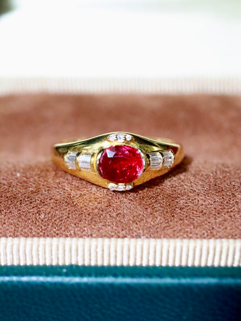 18K Gold Ruby Ring: This 18K Gold Ruby Ring captivates with its stunning vintage style, offering a fashionable and sophisticated taste. The ring showcases a vivid pigeon blood red ruby, expertly set in a substantial