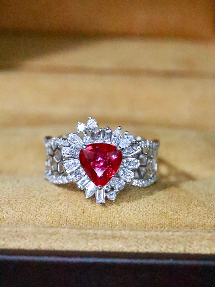 Platinum Ruby Ring: This platinum ruby ring features an exquisite design with interwoven patterns that create a captivating three-dimensional effect. The openwork setting of the ring band enhances its presence, making