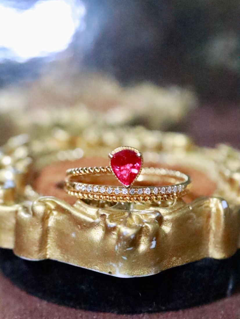 18K Gold Ruby Ring: This 18K Gold Ruby Ring captivates with its exquisite charm, embodying a sense of sophistication with its pigeon blood red hue. The vibrant color of the ruby is both striking and elegant, ensuring it