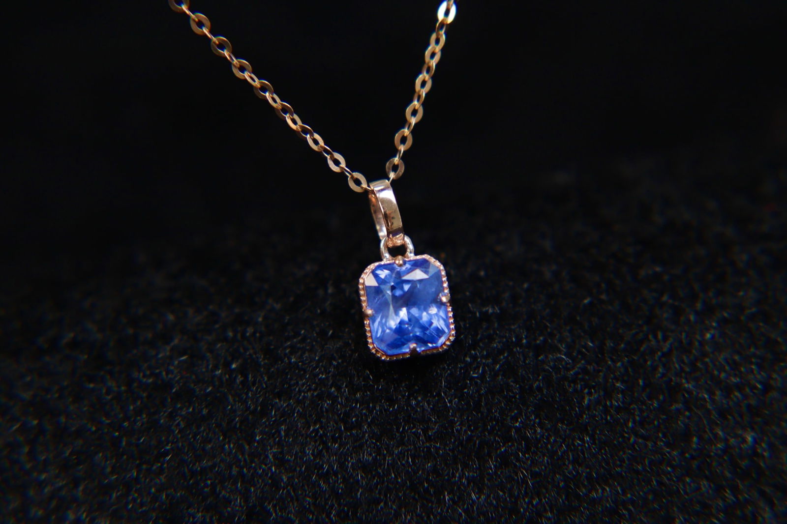 18K Gold Sapphire Pendant: This pendant is a stunning embodiment of elegance, crafted from luxurious 18K gold and featuring a captivating natural sapphire. The deep blue hue of the sapphire is beautifully complemented by the