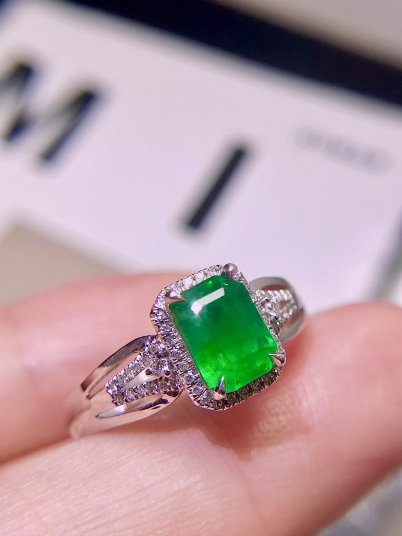 18K Gold Emerald Ring: This 18K Gold Emerald Ring embodies a refreshing and clean simplicity that is effortlessly versatile. Its vivid green emerald captivates with a depth of color that exudes an air of sophistication.