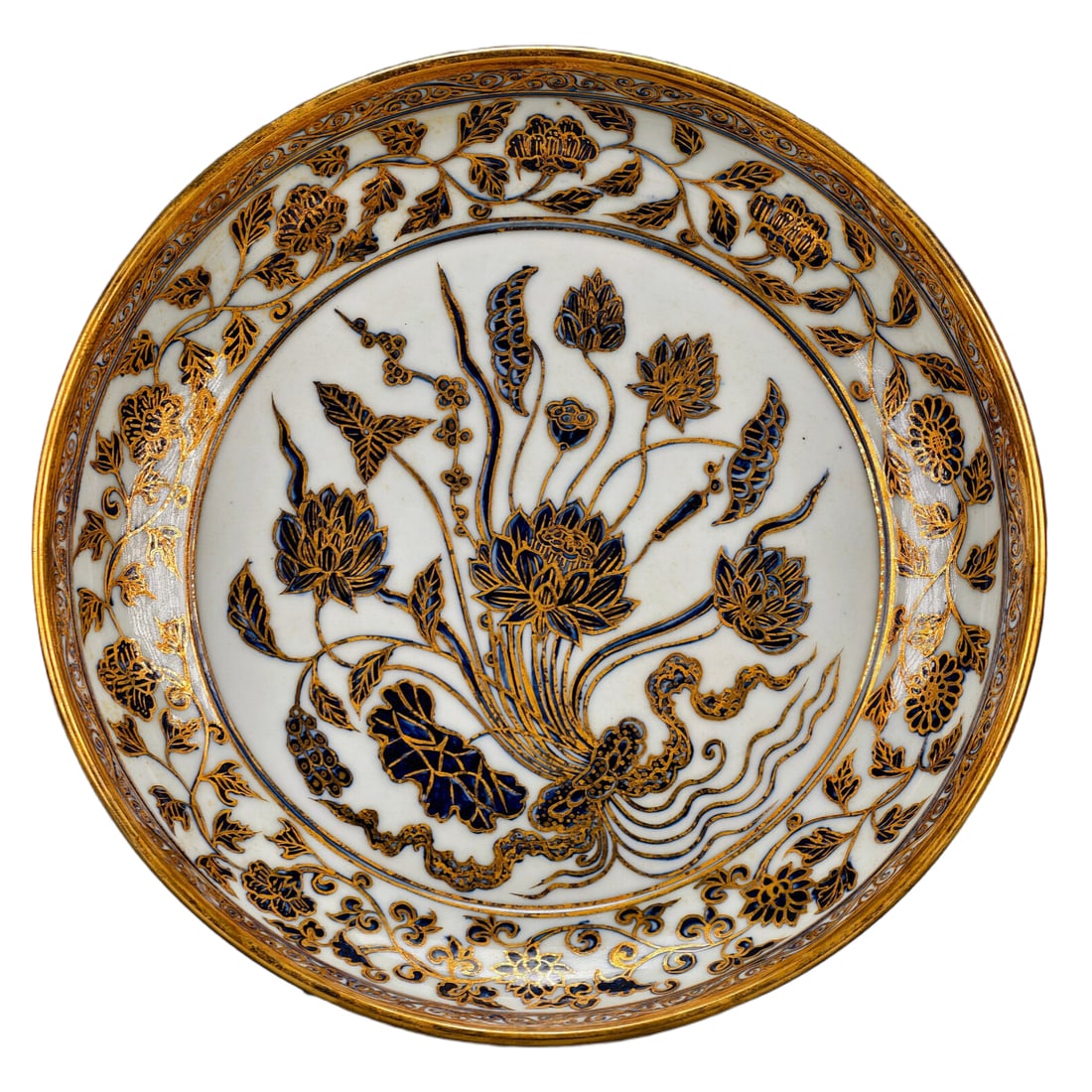Ming Dynasty Xuande Period Blue and White Plate: A blue and white porcelain plate from the Xuande period of the Ming Dynasty, fully painted with intertwined branches of peonies and other flowers, featuring a motif of "a bundle of lotus" on an open w