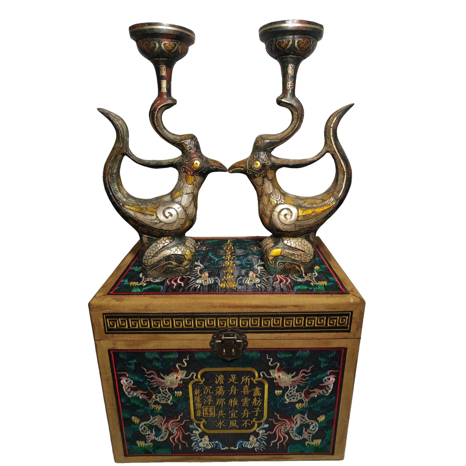 A pair of Qing Dynasty Qianlong period bronze candle holders.: A pair of bronze candlesticks from the Qianlong period of the Qing Dynasty, with copper inlaid with gold and silver, featuring a well-proportioned shape, rich patina, and flawless condition. A