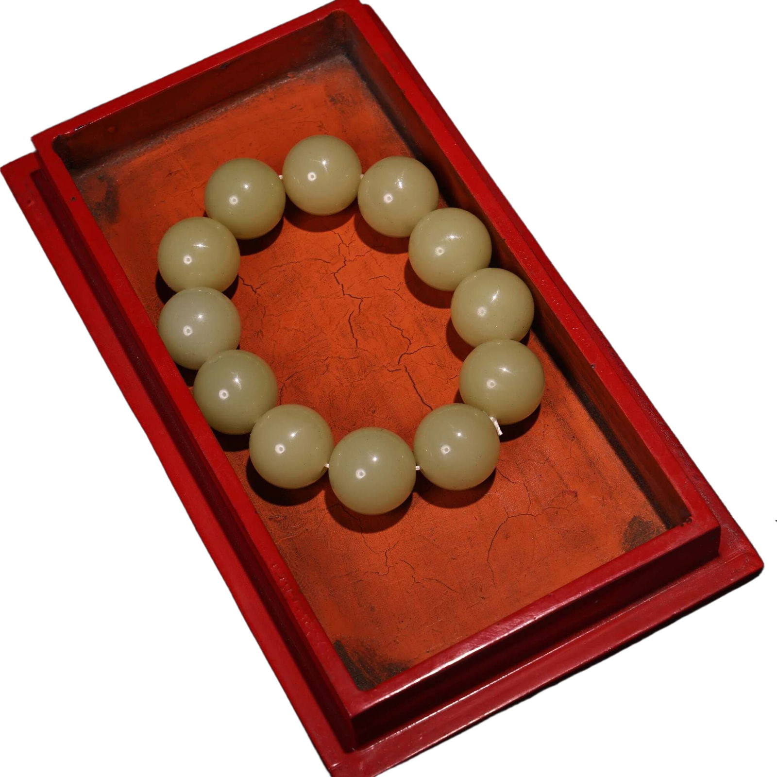 Embossed lacquerware box containing a jade bracelet.: Antique Tibetan carved lacquerware box containing a jade braceletBead diameter 1.8 centimeters