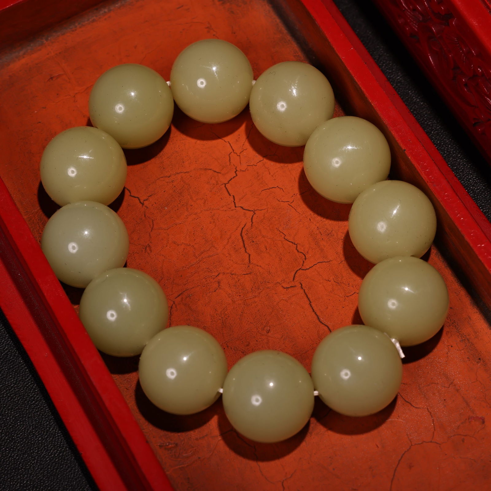 Embossed lacquerware box containing a jade bracelet. - 4