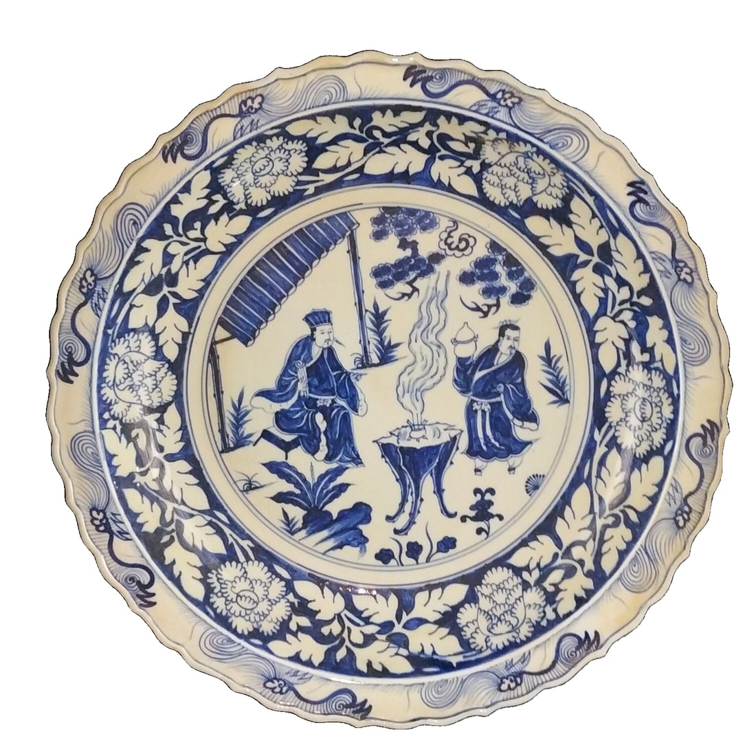 Blue and white hand-painted porcelain plate with human figures and stories.: This Yuan Dynasty blue and white hand-painted plate features a dignified shape with a wide rim and slightly wavy edges, showcasing a unique aesthetic style. The plate surface is decorated with blue