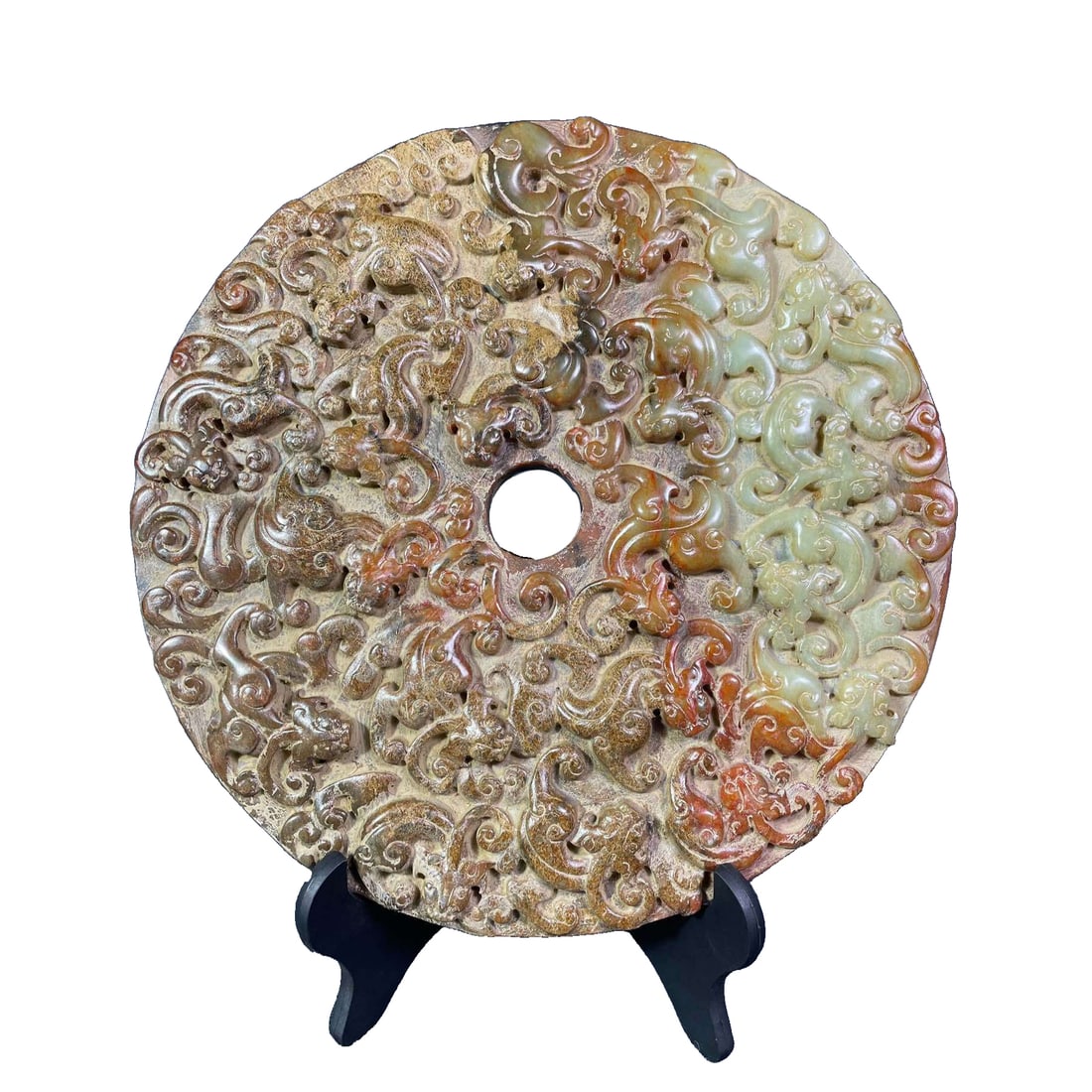 Hetian jade dragon and phoenix jade bi: This Hetian jade bi features a design of a dragon and phoenix, with a diameter of 28 centimeters, a thickness of 2.5 centimeters, and a weight of 6.6 catties. The bi is circular in shape, with a simpl