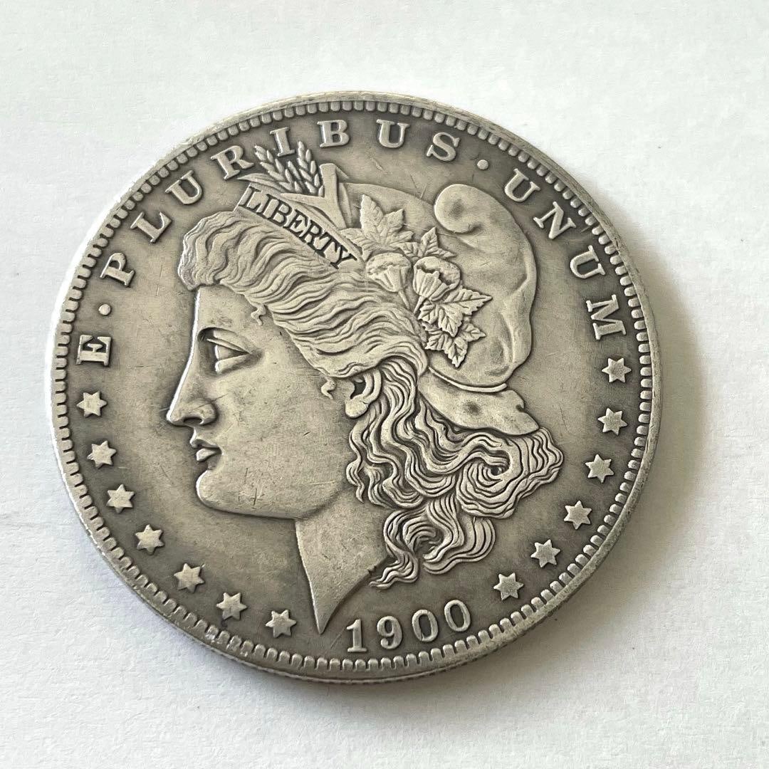 1900 Morgan Silver Dollar (Morgan Foreign Coin): In 1900, Morgan Silver Dollar featuring the design of an eagle was minted. It has a diameter of 38.1 millimeters.Year: 1900Design: Morgan Silver DollarReverse Inscription: In God We TrustCountry: Unit