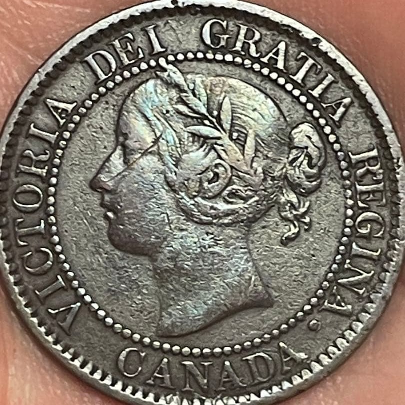 Canadian Confederation 1859 blue toned 1 cent copper coin: This is a 1-cent copper coin issued in Canada in 1859. It is an antique coin that is over 100 years old.It has a rare blue tone.Diameter: approximately 25.5 millimetersWeight: approximately 4.31 grams