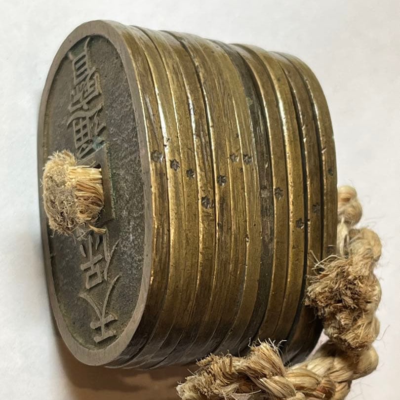 Coins from the Edo period, Tenpo Tsuho.: These are genuine coins circulated during the Edo period under the rule of the shogunate.While three Kan'ei Tsuho coins are relatively common, a string of Tenpo Tsuho coins is extremely rare.I believe