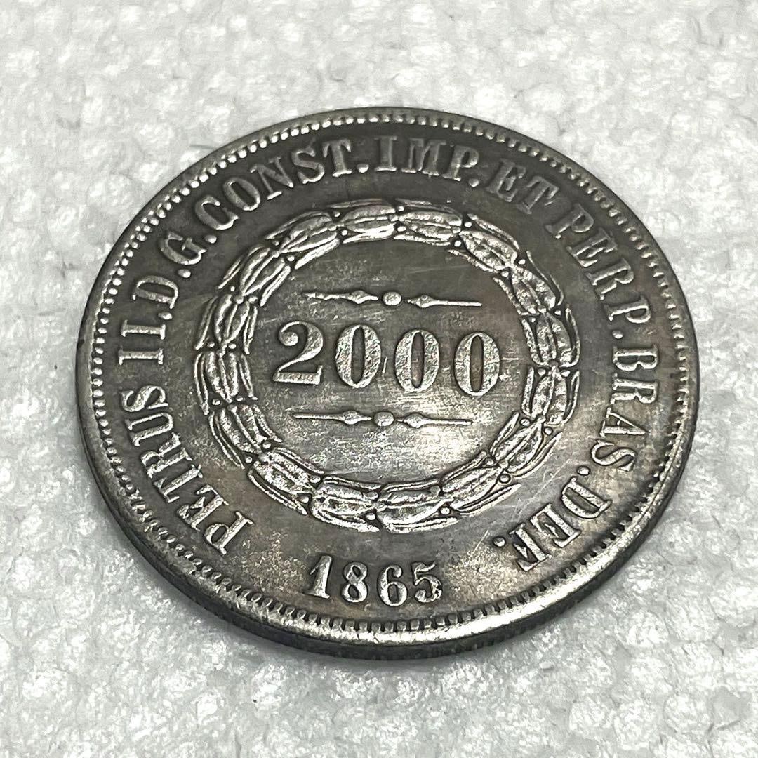 A 2000 real coin from Brazil in the year 1865.: The 2000 real coin issued in 1863 features a crown and a ship emblem.Diameter: approximately 38.1 millimetersWeight: approximately 20.1 grams