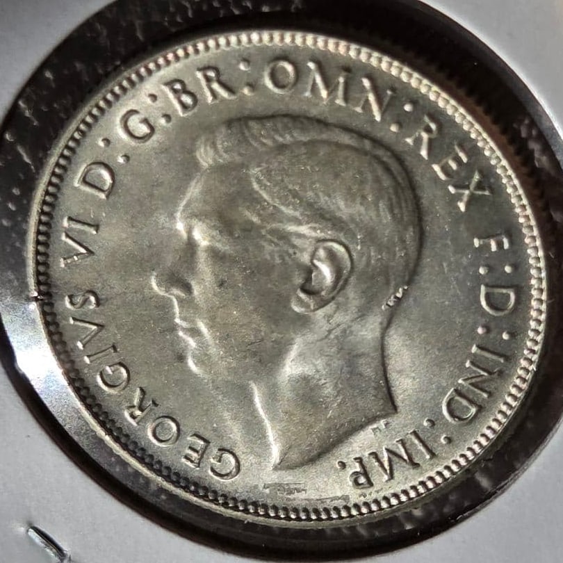 Australia Commonwealth George VI 1 Florin silver coin, 1946: This is a 1946 Australian florin silver coin.It was only minted for two years, in 1946 and 1947.The portrait on the coin is of King George VI.The reverse side features a kangaroo and an emu supporting