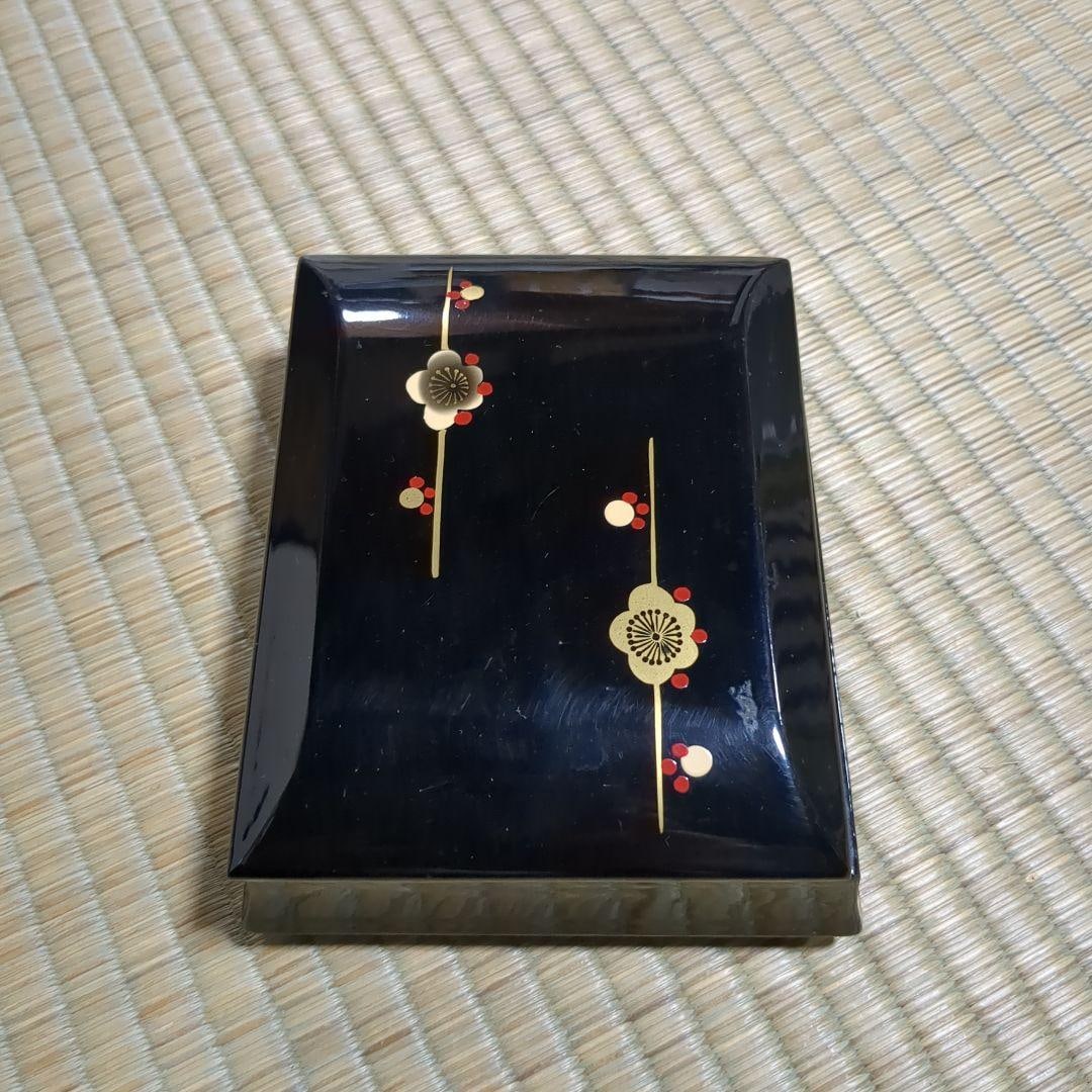 Lacquer storage box decorated with a golden plum blossom pattern.: Lacquer storage box decorated with a gold plum blossom pattern on a black lacquer finish.DimensionsBase dimensions: approximately 11.5 x 14 centimeters (this is the largest size due to its