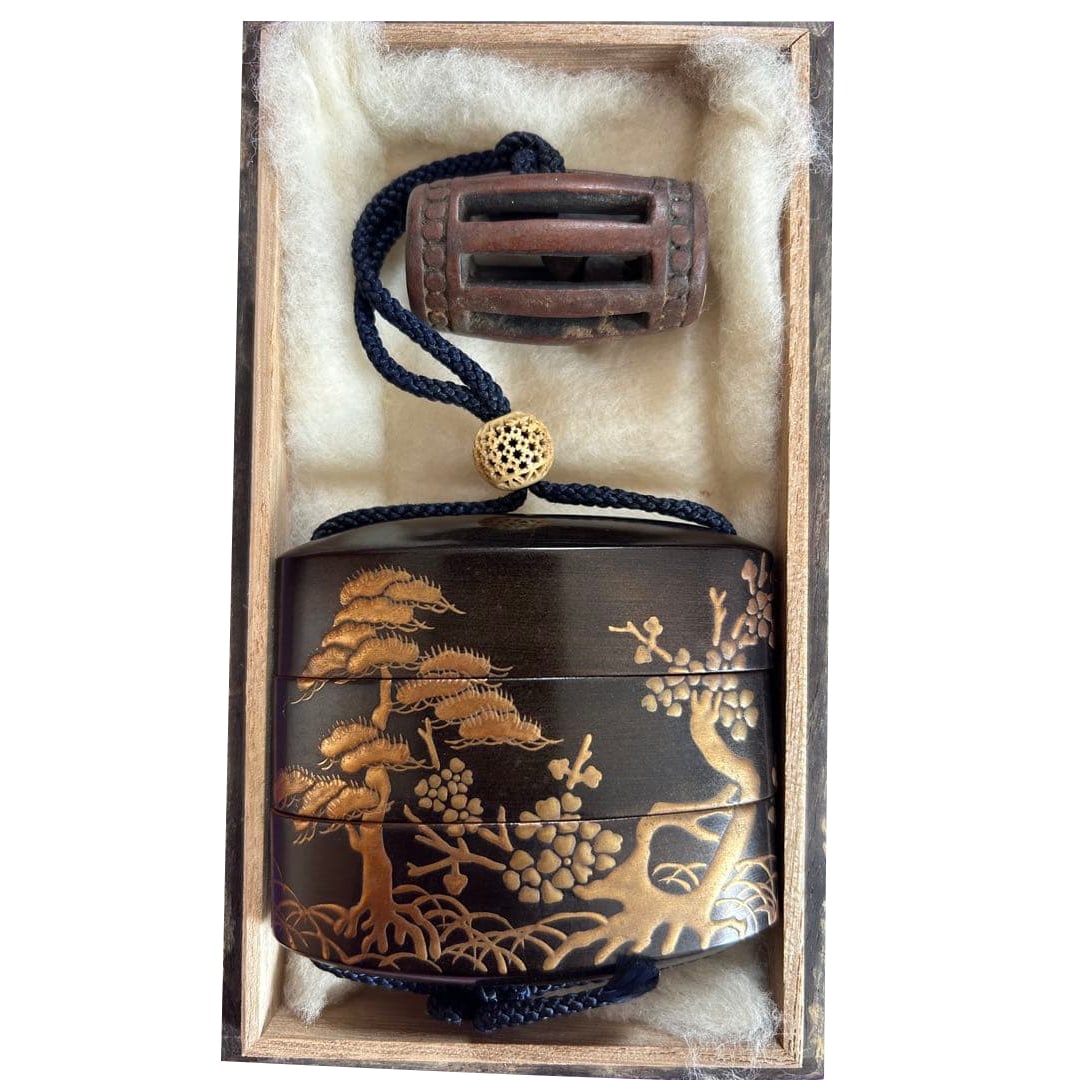 The box is decorated with landscape patterns.: Lacquer box (small decorative container) decorated with exquisite gold foil.Design: Bird and plum blossom patterns decorated with gold foilMaterial: LacquerColors: Black and goldShape: