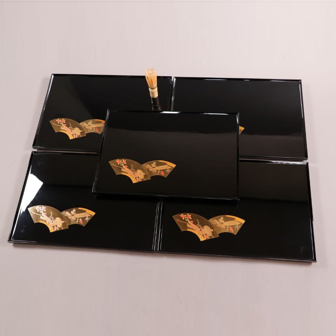 Katsurazaka fan-shaped lacquerware tray set with seasonal illustrations, five pieces.: This is a set of five beautifully decorated black lacquer trays featuring gold lacquer designs depicting festivals from five different seasons. They are made by the longstanding Kizuka Lacquerware Sto