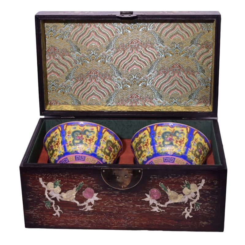Inside the rosewood box is a Qianlong period famille rose bowl with dragon design. (1 of 10)