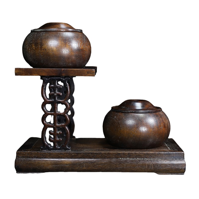 A pair of antique Tibetan rosewood Go game canisters, matched with a rosewood base.: A pair of antique Tibetan rosewood Go game canisters, matched with rosewood bases. Each Go game canister is 14 cm wide and 9 cm high, while the base is 32.5 cm long, 15 cm wide, and 20 cm high. The