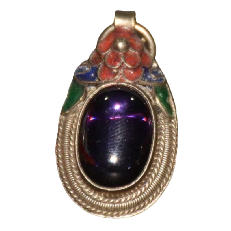 CloisonnE inlaid gemstone pendant: Copper-based handcrafted cloisonnE pendant with inlaid zircon gemstones. It is 2 cm long, 1 cm wide, and 4 cm thick, weighing around 12 grams.