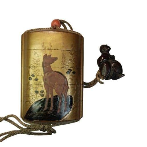 A gold lacquer inrO (small container), decorated with deer motifs, carved from boxwood. (1 of 17)