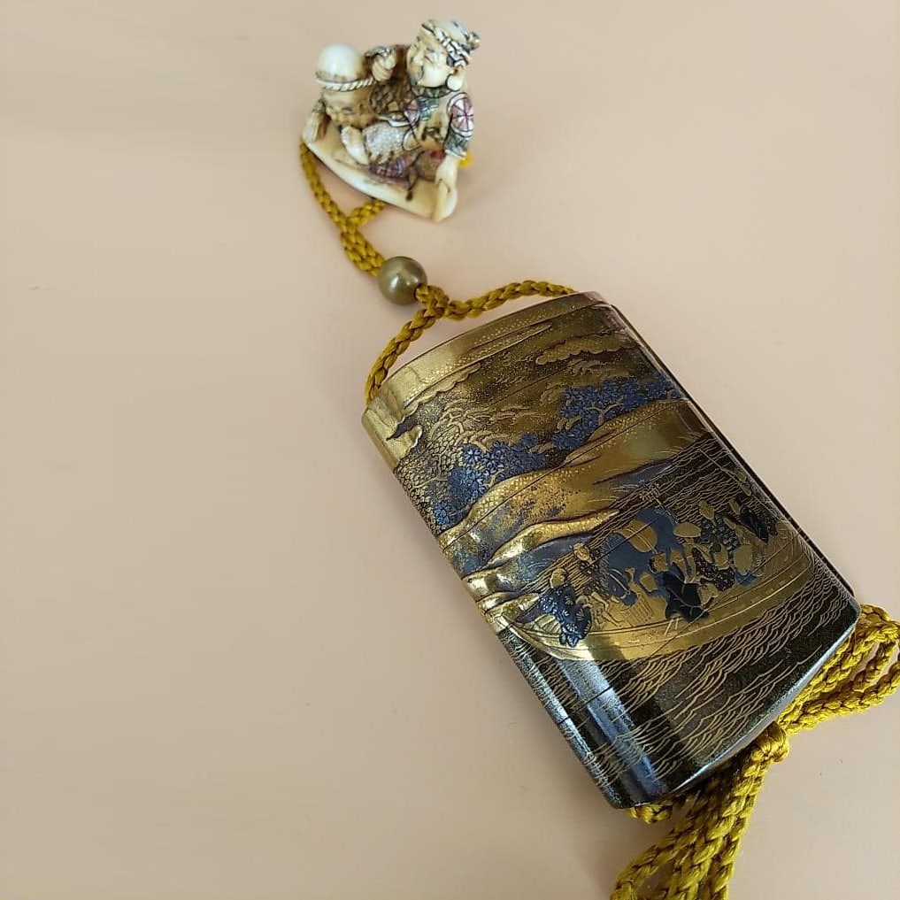 A gold and silver lacquered inro in the shape of a ferry boat (small container), containing a (1 of 20)