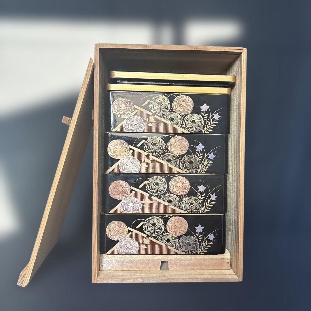 A wooden lacquered bento box, adorned with chrysanthemum motifs and maki-e (gold lacquer) (1 of 19)