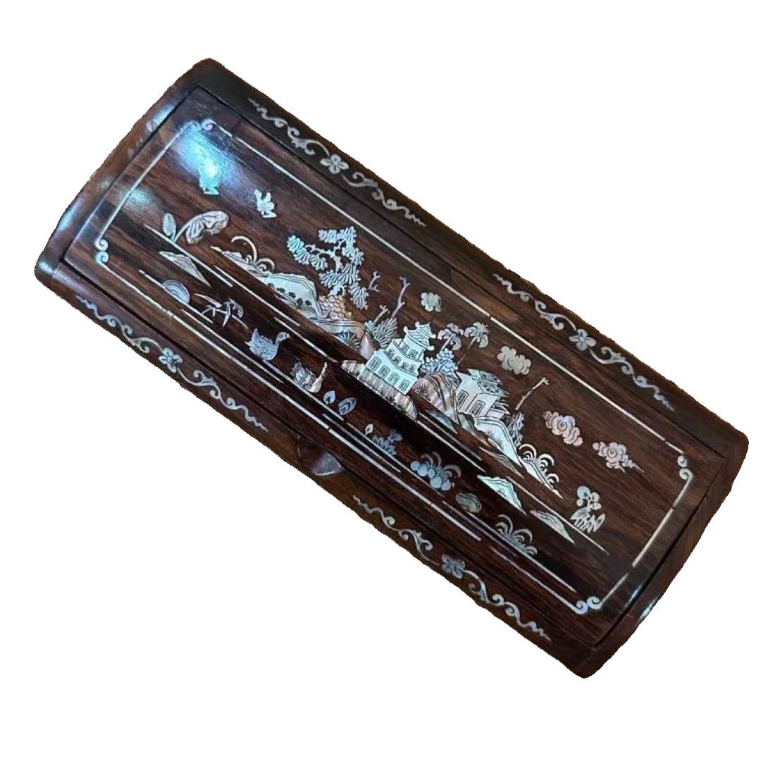 A wooden jewelry box inlaid with mother-of-pearl, decorated with landscape motifs.: This is an exquisite wooden jewelry box adorned with mother-of-pearl inlay. The delicate shell decoration depicts buildings and natural landscapes, creating a serene atmosphere that blends well with b