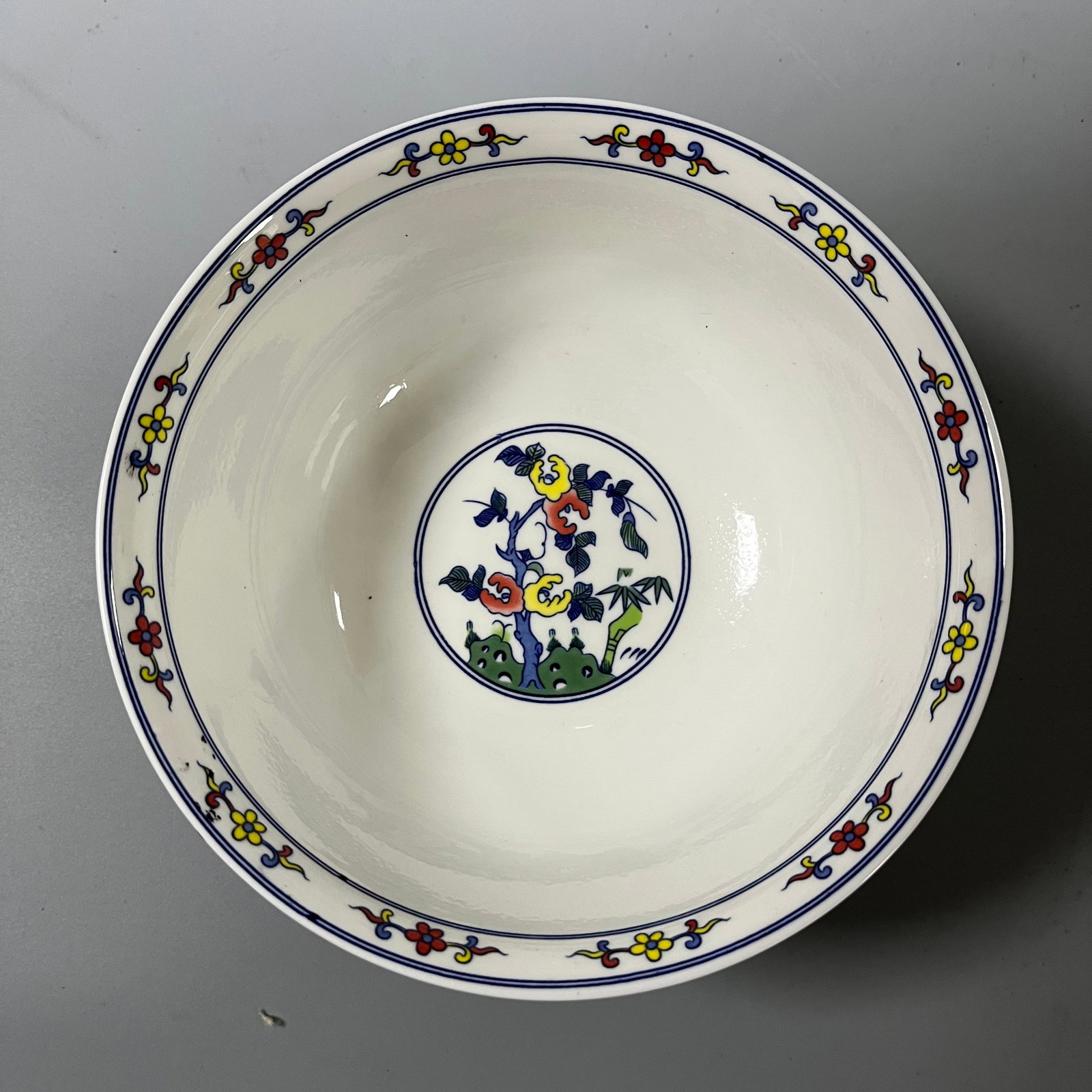 A doucai bowl with lotus scroll design from the Qianlong period of the Qing Dynasty: This Qing dynasty doucai (enamel overglaze enamel) bowl with a lotus scroll design measures approximately 15.5cm in diameter and 7.5cm in height. It is well-proportioned, with a slightly flared rim, d