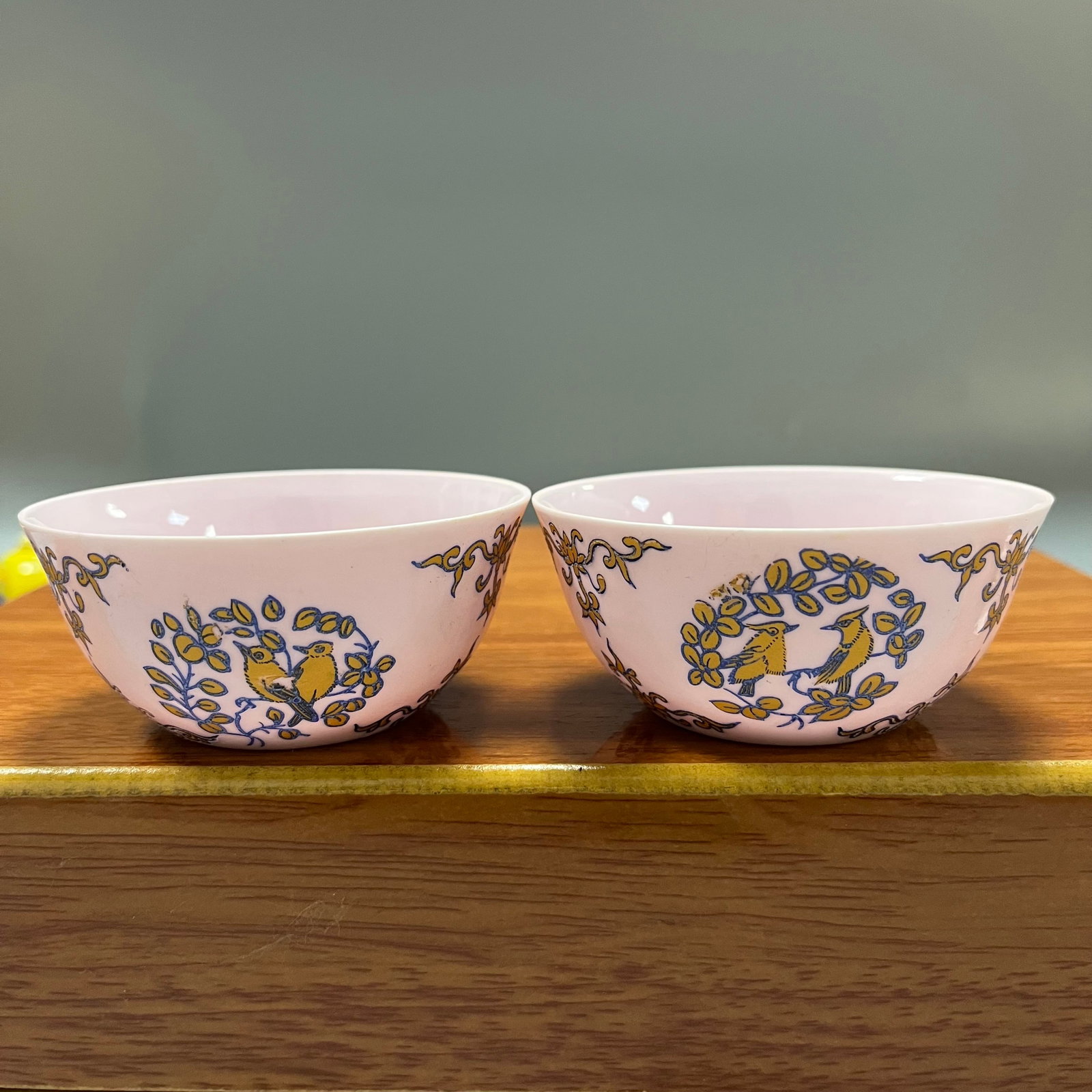 Ming Dynasty Chenghua Period Pink Ground Five-Color Floral and Bird Pattern Tea Cup Set: A set of tea bowls with famille rose enamels on a pink ground, each measuring 3.5 x 8 cm, dating from the Chenghua period of the Ming Dynasty. The entire set is covered in a delicate pink glaze, with