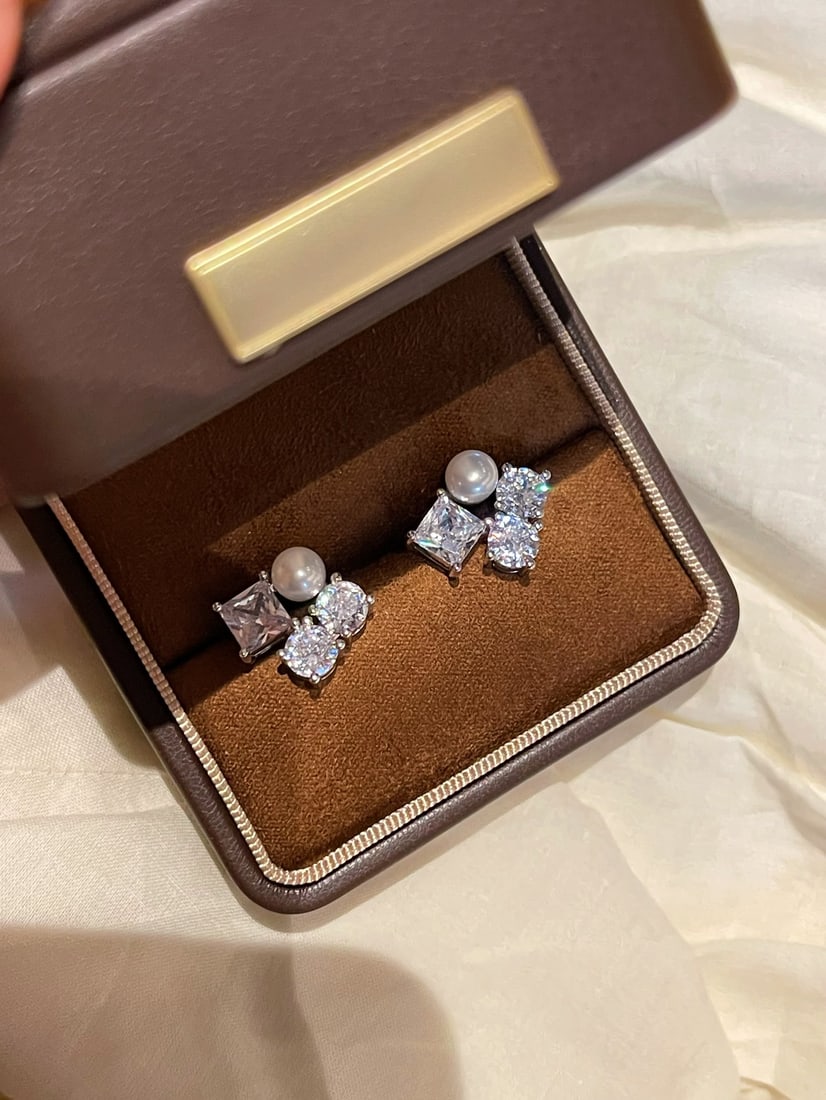 Pearl Zircon Earrings: This pair of earrings is a masterpiece of refined elegance, featuring a unique design where square zircon stones gracefully connect to natural freshwater pearls. The exquisite craftsmanship is